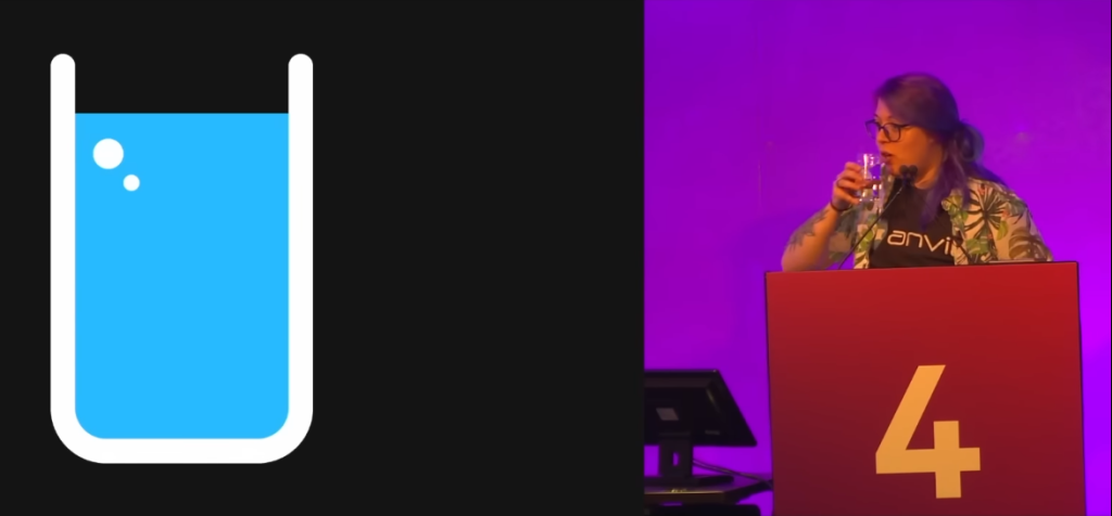 A screenshot from a YouTube video showing a slide on the left with a graphic of a glass of water. On the right is me, the speaker, taking a drink of water.